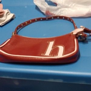 A red and pink purse. With a h on it for kids.
